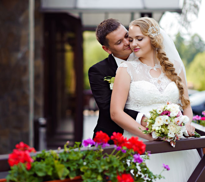 Bride and groom at a luxury destination wedding with floral mandap